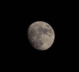 Lunar phases rising over the city in night sky