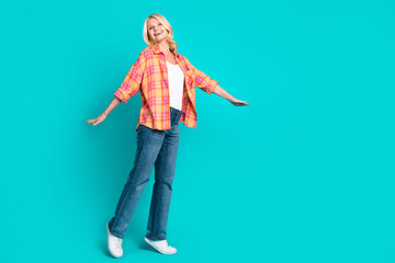 Photo of positive cute senior woman wear nice stylish clothes empty space isolated on cyan color background