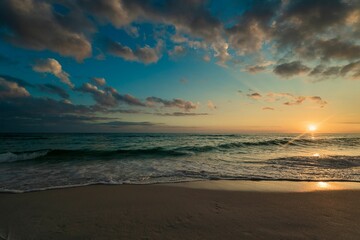 Idyllic beach scene featuring a beautiful sunset over the ocean in Destin, Florida