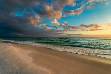 Idyllic beach scene featuring a beautiful sunset over the ocean in Destin, Florida