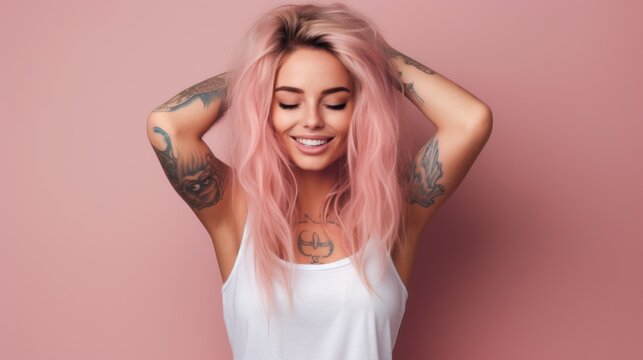 A woman with pink hair and tattoos is smiling and holding her hair up