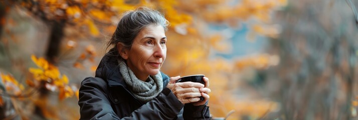 Mature Woman Contemplating Autumn with Coffee Cup - obrazy, fototapety, plakaty