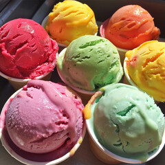 Bright multi-colored ice cream balls in waffle cones. Summer mood. Summer solstice day.