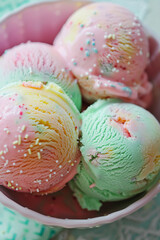 Pastel pink and mint ice cream balls in a white bowl. Summer mood. Summer solstice day.