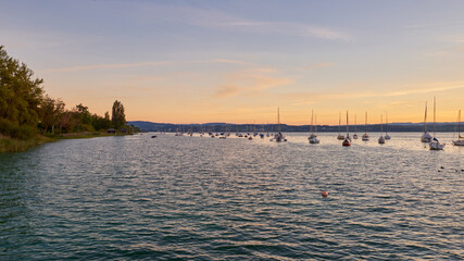 Naklejka premium Bodensee Lake Sunset Panorama. Evening Sunlight Over Tranquil Waters. Sunset Vista at Lake Bodensee in Germany.
