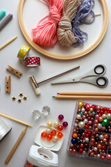 Various craft supplies on white background. Supplies for jewelry making, drawing and needlework. Flat lay.