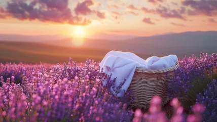 Muurstickers Basket of fresh laundry against lavender field, breeze, sunset © Anuwat