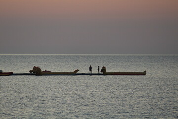 Naklejka premium silent scene of two people on water rides in the Black Sea early in the morning