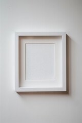 One white picture frame with portrait ratio and blank inside, hanging on an empty wall with a white background.