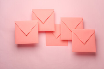 Square paper pink envelopes on pink background