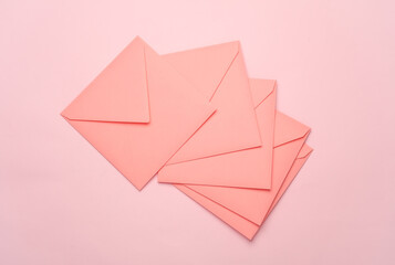 Square paper pink envelopes on pink background