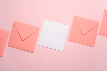 Square paper pink and white envelopes on pink background