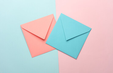 Blue and pink square paper envelopes on blue pink pastel background