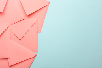 Pink square paper envelopes on blue pink pastel background