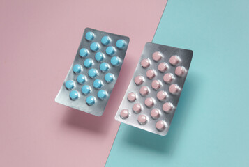 Blue and pink blisters of tablets on a pastel background. Medicine concept. Top view. Flat lay