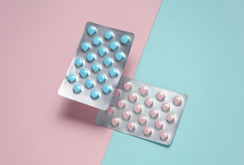 Blue and pink blisters of tablets on a pastel background. Medicine concept. Top view. Flat lay