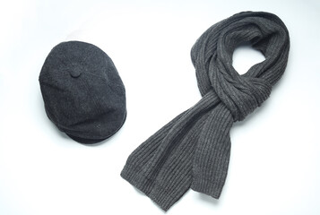 Vintage woolen English eight-piece cap with scarf on a white background. Gentleman's accessories