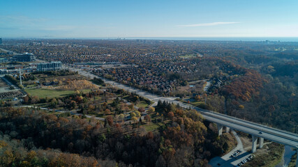 An aerial view at sunrise of a bridge going over a valley and River