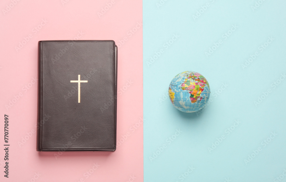 Wall mural bible book with globe on a pink blue background. christian religion - Wall murals