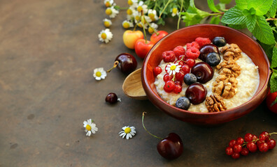oat porridge with fresh berries for breakfast
