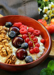 oat porridge with fresh berries for breakfast