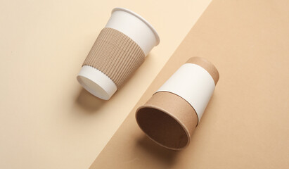 Cardboard cups for hot drinks on beige background