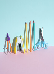 Stationary school supplies on pastel background with shadow