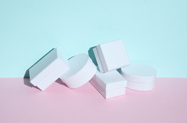 White cardboard boxes on a blue-pink pastel background