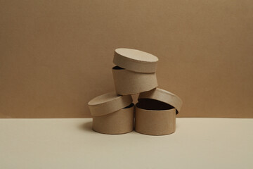 Round craft cardboard boxes for product on beige background