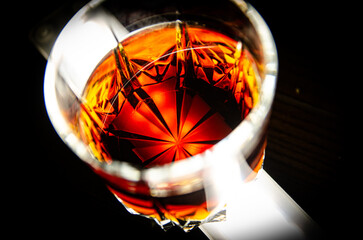 whiskey in a small glass with a dark background