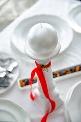 white christmas decoration with candlestick and candle for easter