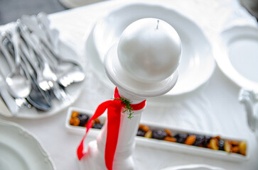 white christmas decoration with candlestick and candle for easter