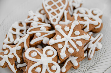 brown fresh gingerbreads with white decorative icing in various shapes