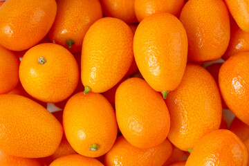 Close up background of kumquat fruits. Top view - obrazy, fototapety, plakaty