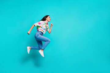 Photo of crazy positive nice woman dressed stylish print clothes look empty space hurry isolated on cyan color background