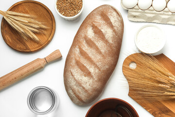 Cooking ingredients and kitchen utensils, bread on white background. Top view. Flat lay
