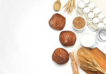 Buns with Cooking ingredients and kitchen utensils on white background. Top view. Flat lay