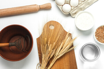 Cooking ingredients and kitchen utensils on white background. Top view. Flat lay
