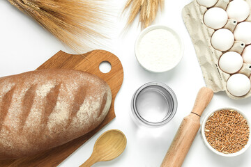Bread with Cooking ingredients and kitchen utensils on white background. Top view. Flat lay
