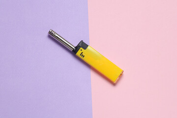 Household lighter on a pastel background. Top view