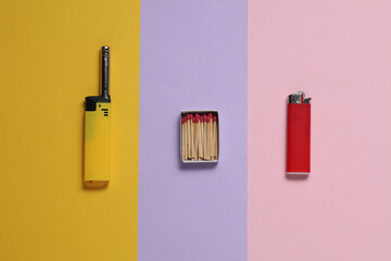 Lighters and matches on pastel background. Flat lay