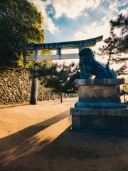 Tuinposter Lion Statue Guarding The Torii Gate  © francescosgura