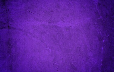 A textured purple concrete wall with a prominent vertical crack. 