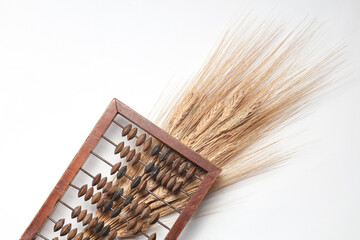 Abacus and spikelets of wheat on a white background. Food crisis