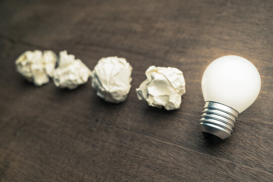 Many crush paper balls lead to the glowing light bulb at the end, learn from mistake, original idea