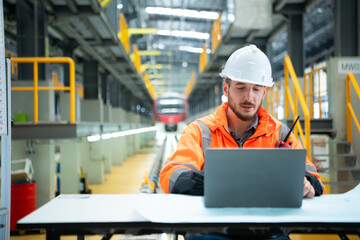 Portrait of Young male technician sitting on the table in skytrain repair station, Check the...