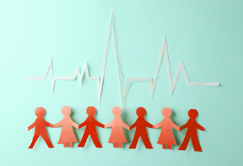 People Chain with a cardiological heart rhythm cut out of paper on blue background. Nation health - obrazy, fototapety, plakaty