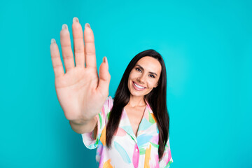 Photo of pretty young woman arm palm waving hi wear shirt isolated on teal color background