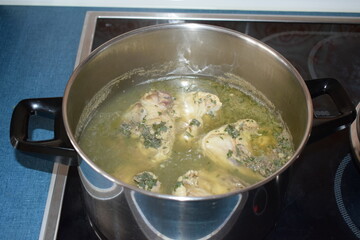 chicken legs cooking in soup