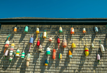   wooden barn wall with a collection of various floats. Traveling around the USA. - 770799468